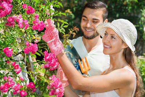 Gardener performing safe maintenance with tools in a residential garden