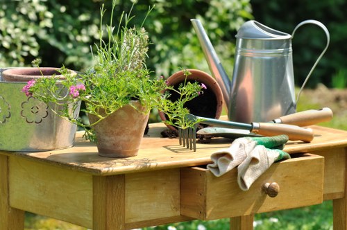 Gardener working in a Mortlake garden next to terraced houses